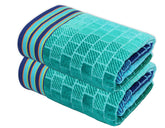 The Cotton Craft Blue Tiles Velour Beach Towel 2-pack for comfortable beach lounging.