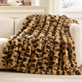 Cozy Bliss Cheetah Leopard Faux Fur Throw on couch for warm, stylish evenings