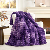 Cozy Bliss faux fur throw blanket on a couch offers plush warmth and versatile décor.