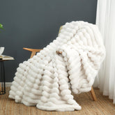 Cozy Bliss faux fur blanket on sofa adds warm, stylish texture.