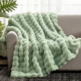 Cozy Bliss faux fur throw blanket in sage green on couch delivers cozy warmth