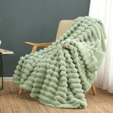 Cozy Bliss faux fur throw blanket draped over sofa for plush warmth and texture.
