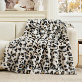 Cozy Bliss leopard faux fur throw face highlights plush texture for sofa coziness.