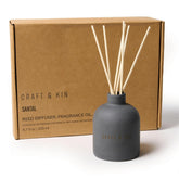 Craft & Kin Santal Woods reed diffuser bottle with sticks for long-lasting warmth