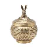 Creative Co-Op round hammered metal container with brass finish enhances any display.