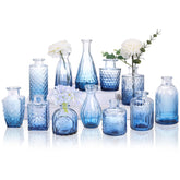 CUCUMI 12-pack blue glass bud vases for elegant table centerpieces.