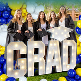 Deerher GRAD sign with cap glows for festive photo backdrop