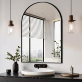 Delma arched mirror in black, wall-mounted to brighten and visually expand spaces.