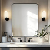Delma bathroom mirror with black frame over sink offers clear, easy grooming reflections.