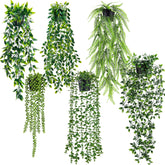 Der Rose hanging eucalyptus vines in black pots for versatile indoor decor.