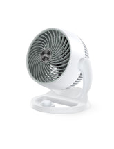 Dreo 12-inch desk fan in a bedroom delivering broad airflow.