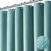 Dynamene teal waffle fabric curtain adds texture and privacy to a modern bathroom