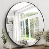 Easly 42-inch round mirror with black frame enhances bathroom style and clarity.