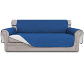 Easy-Going reversible couch cover in blue and ivory on a 3-cushion sofa, protecting furniture.