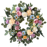 Ecerangus spring wreath on front door with white hydrangea and eucalyptus.