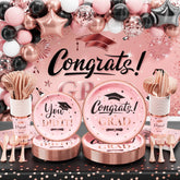 Ecomore graduation backdrop in pink and rose gold, ideal for photo moments.