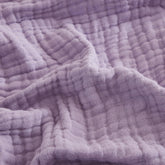 EMME cotton throw blanket lavender on couch offers cozy all-season comfort.