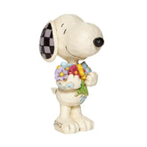 Enesco Snoopy by Jim Shore holding spring flowers figurine, a charming gift for Peanuts fans.
