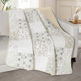Exclusivo Mezcla 50x60 quilted throw with boho patchwork on bed for cozy decor.