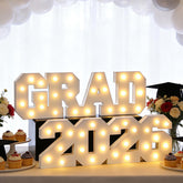 FestalMart Grad 2026 light-up letters, front view, creates a bright graduation backdrop.