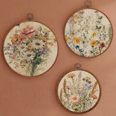Fiwochic round wildflowers art 10x10 framed displays vibrant multicolor blooms in a cozy living room.