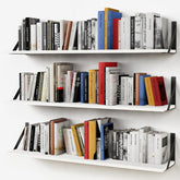 Forbena white floating shelves on wall offering a clean display and extra storage.