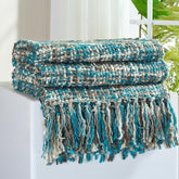 GINAMUSE multi-color teal cable woven throw on couch adds cozy decor.