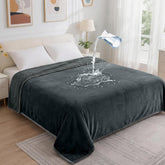 Groose waterproof blanket on bed close-up shows spill protection and plush flannel surface.
