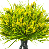 Grunyia artificial monkey grass with yellow flowers serves as a vibrant centerpiece