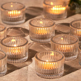 HAVITI 24-pack clear tealight holders for elegant wedding centerpieces and ambient home decor.
