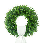 Hecaty boxwood wreath on front door with white sash enhances curb appeal