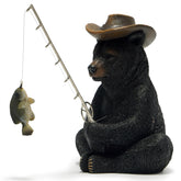 Hodao black bear fishing figurine on desk adds whimsical coastal decor.