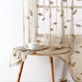 HOMEIDEAS taupe sheer curtains with embroidered leaves create natural elegance and soft lighting.