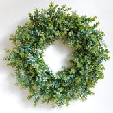 HomeKaren 24-inch front door wreath with eucalyptus and camellia adds year-round charm.