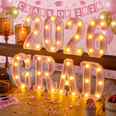 Honoson Grad 2026 pink LED sign lighting up graduation tables