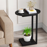 Hosfais small side table with oval C-shape in black beside the sofa for easy reach