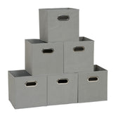 Household Essentials fabric storage bin with front grommet handle for easy shelf access.