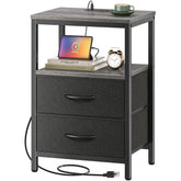 Huuger nightstand with charging station beside the bed keeps devices powered.