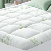 HYLEORY bamboo cooling mattress topper laid on bed for cool comfort