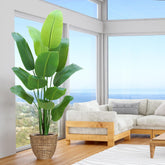 HZXGCP Bird of Paradise 6ft artificial tree enhances living room decor with tropical elegance.