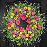 ICX spring wreath with tulips and wildflowers on the front door.