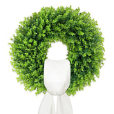 IDOGliitte boxwood wreath with folding base for space-saving entryway decor.