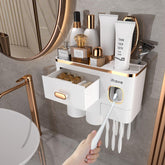 iHave toothbrush holder wall-mounted with toothpaste dispenser in white and gold, for a clutter-free vanity.