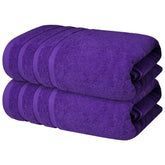 Infinitee Xclusives bath towel folded in Profound Purple for luxurious post-bath comfort