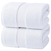 Infinitee Xclusives jumbo bath sheets rolled for compact storage and quick drying.