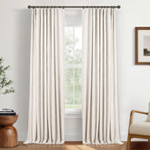 INOVADAY beige blackout curtains offer serene, dimmed lighting in a living room.