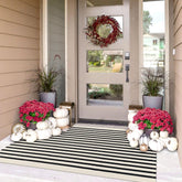 IOHOUZE black-beige striped rug laid on a front porch for welcoming style