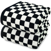Jacquotha bath towels in black-white checkered folded, plush and absorbent.