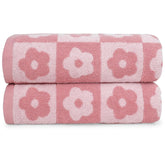 Jacquotha checkered floral towels folded, showing plush texture for quick drying.