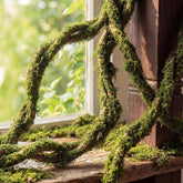 Janinka bendable tree branches with moss create a lush outdoor backdrop.
